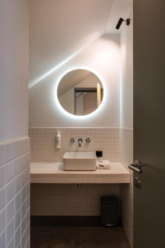 a bathroom with a sink and a mirror at BURSA Hotel Kyiv in Kyiv
