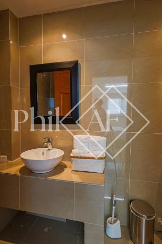 a bathroom with a sink and a mirror at 10 bed-rooms luxury BEACH VILLA in Guana Bay