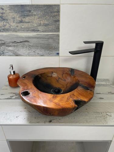 a wooden sink sitting on top of a counter at Pecslux in Pécs