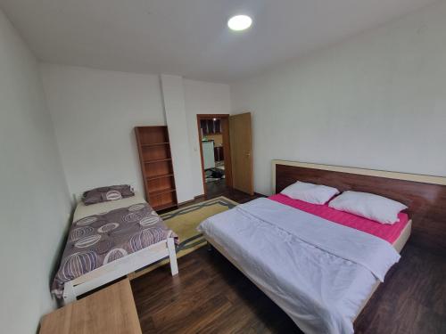 a bedroom with two beds in a room at Apartman Vany in Tuzla