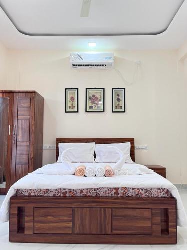 a bedroom with a large bed with two pillows at Paradise Villa with pool table and big garden in Lonavala