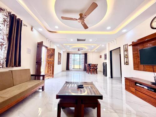 a living room with a couch and a ceiling fan at 5bhk- Nature Villa in Lonavala