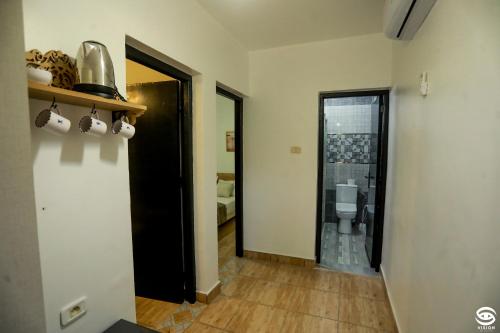a hallway with a bathroom and a toilet in a room at Dar Barka in Kebili