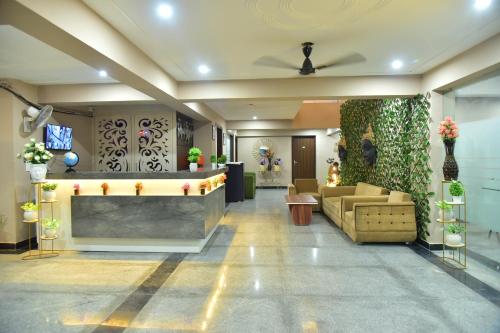 a lobby with a waiting area with a couch at Hotel Wedlock Premium Medanta in Gurgaon