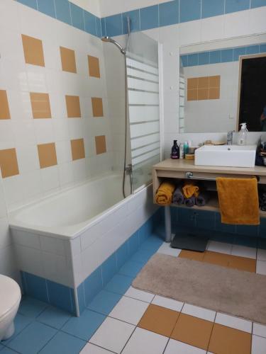 a bathroom with a tub and a sink and a toilet at T2 avec piscine et accès privé à la mer in Sanary-sur-Mer