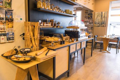 a kitchen with a counter with some food on it at Hôtel Les Charmettes - Saint Malo in Saint Malo
