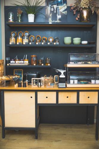 a kitchen with a counter with some items on it at Hôtel Les Charmettes - Saint Malo in Saint Malo