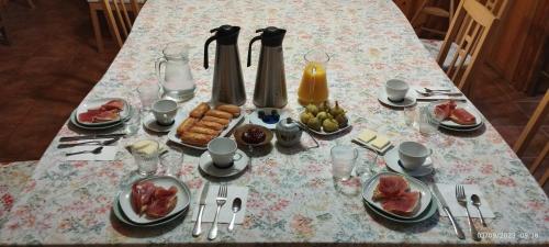 a table with a table cloth with food on it at La Casa Verde in Islallana