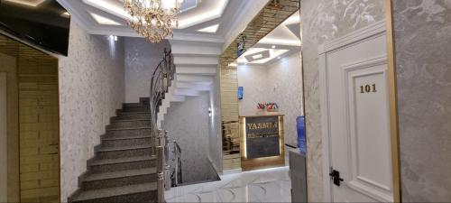 a staircase in a building with a chandelier at YASMIN in Samarkand