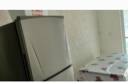 a white refrigerator freezer sitting in a kitchen at Casa de descanso in Acapulco
