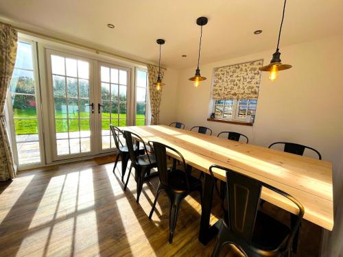 a conference room with a long wooden table and chairs at Old Post Office in Sherborne