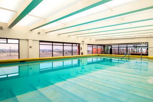 a large swimming pool with blue water at Camino Real Aeropuerto in Mexico City