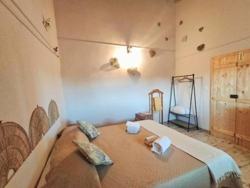 a bedroom with a bed with two pillows on it at Refúgio na Aldeia in Ourique