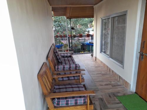 a hallway with stairs leading up to a porch at Bethel homestay Delo in Kalimpong