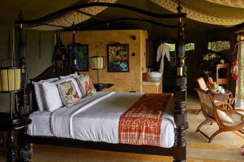 a bedroom with a bed with a canopy at Madulkelle Tea and Eco Lodge in Kandy