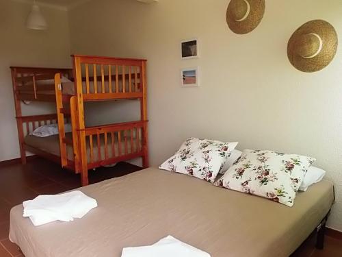 a bedroom with a bed with two pillows at Alojamento Espigas in Azoia
