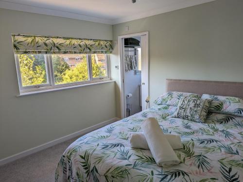 a bedroom with a bed and two windows at Little Barham B&B 