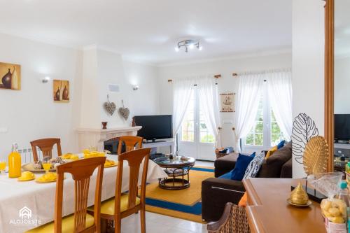 a living room with a table and a dining room at Santa Beach Villa - 3 bedrooms & BBQ in Santa Cruz