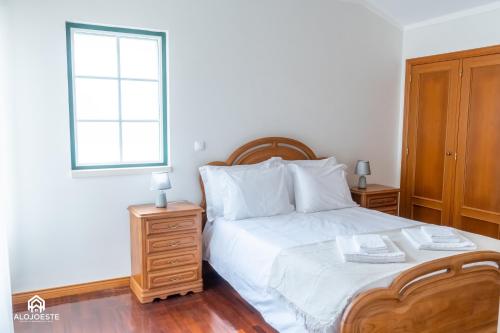 a bedroom with a white bed and a window at Santa Beach Villa - 3 bedrooms & BBQ in Santa Cruz