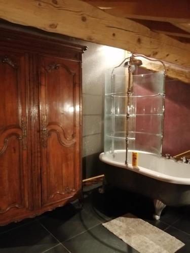 a bathroom with a bath tub and a sink at Lumieres de Courchevel in Bozel