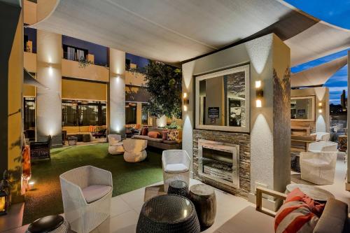 a living room with a fireplace in a house at Protea Hotel Fire & Ice! by Marriott Pretoria Menlyn in Pretoria