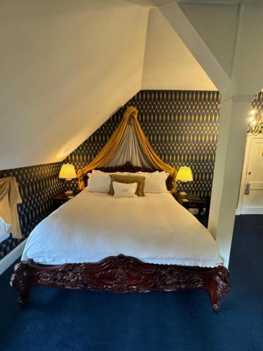 a bedroom with a large bed with a canopy at Antrim 1844 in Taneytown