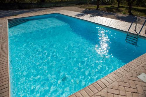 a large blue swimming pool with blue water at Tenute Donna Franca in Elice