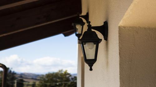 a light on the side of a building with a window at Tenute Donna Franca in Elice