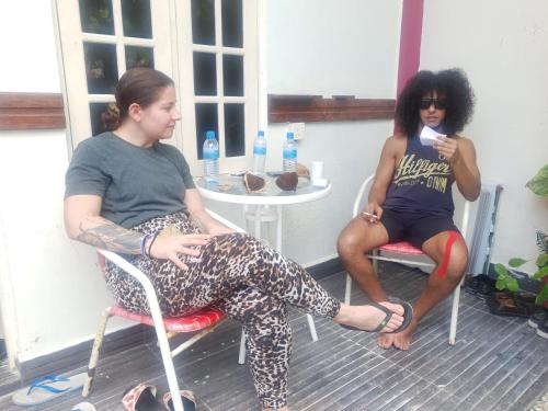 two women sitting in chairs on a porch at Finimas Residence in Thimarafushi