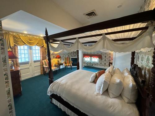 a bedroom with a large bed with a canopy at Antrim 1844 in Taneytown