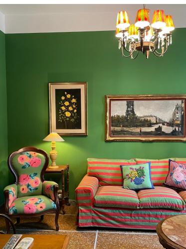 a green living room with a couch and a chair at Casa Mariuccia in Anzio