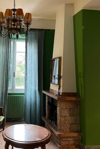 a living room with a fireplace and a table at Casa Mariuccia in Anzio