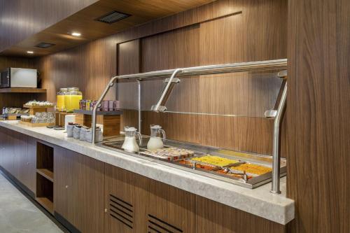 a buffet line in a restaurant with food at City Express Plus by Marriott San Luis Potosi in San Luis Potosí