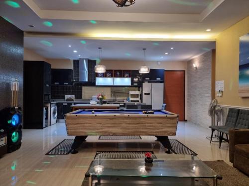 a large living room with a pool table in it at Peter Pan Poolvilla in Jomtien Beach