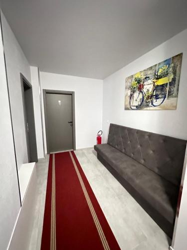 a living room with a couch and a red carpet at Swiss Apartmani in Banja Luka