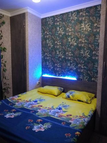 a bedroom with a bed with a blue light at Eriks House in Gyumri