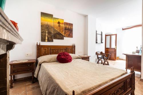 a bedroom with a large bed and a fireplace at Casa Generalife, bei Granada in Dúrcal