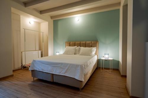a bedroom with a large white bed with two lamps at Romana Boutique in Bucharest