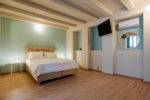 a bedroom with a large bed and a mirror at Romana Boutique in Bucharest