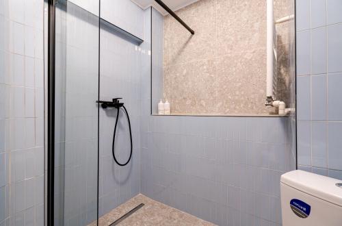 a bathroom with a shower with blue tiles at Romana Boutique in Bucharest