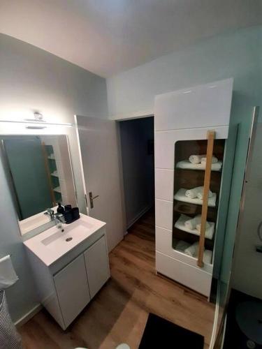 a bathroom with a sink and a mirror at Santo António Guest Apartment in Funchal
