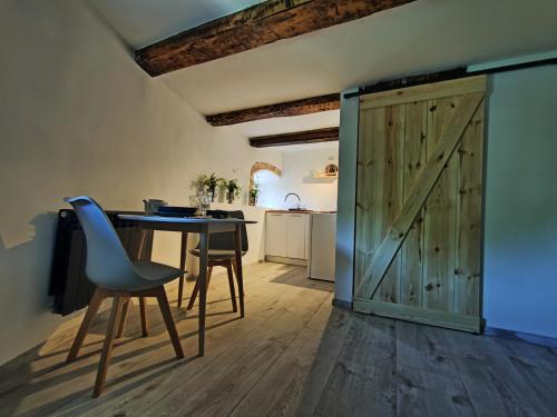 a kitchen and dining room with a table and a barn door at Wieża Gniezno Apartament WIEŻA in Gniezno