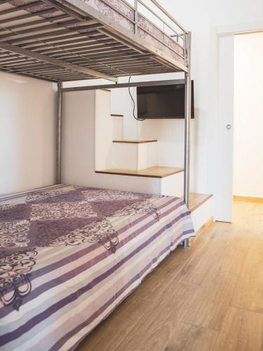 a bedroom with a bunk bed with a television at Tenute Donna Franca in Elice