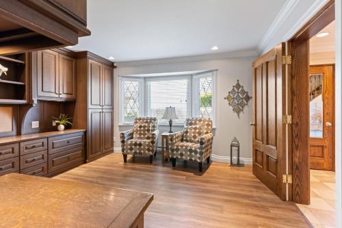 a kitchen with a table and chairs and a dining room at Grand English Style Home in Chilliwack