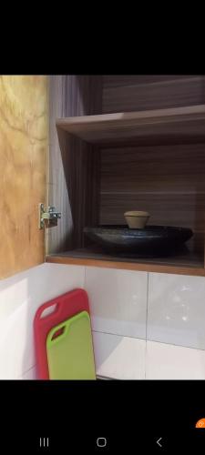 a red and green chair sitting in a kitchen at Natako Apartments in Apenkwa