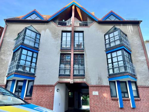 a red brick building with balconies on it at Lüttje Bude - mit Privatparkplatz in Bremerhaven