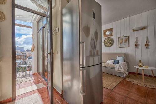 a kitchen with a stainless steel refrigerator in a room at Amaoré, paz, hogar y playa in Alajeró