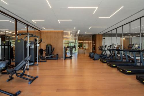 a gym with a row of treadmills and machines at Sheraton Xuzhou in Xuzhou
