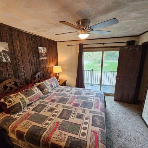 a bedroom with a bed and a ceiling fan at Alpine Retreat @ Seven Springs! in Champion