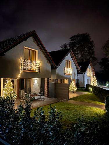 a house decorated with christmas lights at night at Trzy Wyspy Barlinek in Barlinek
